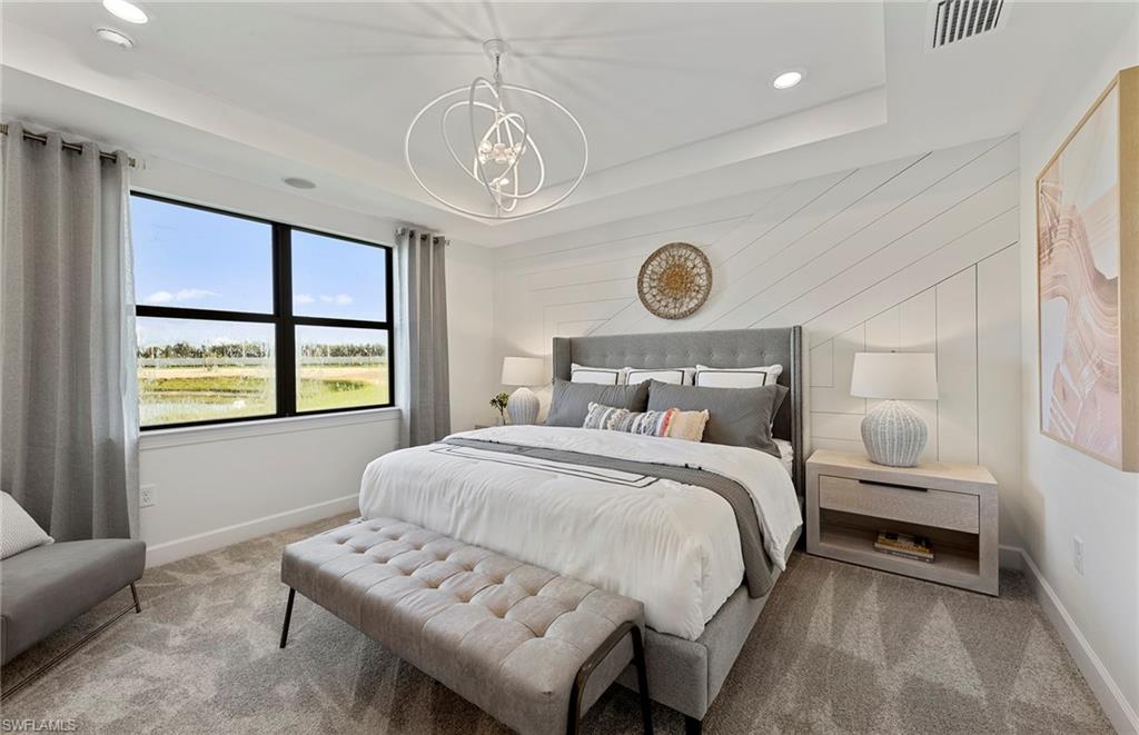 2142 Yellowfin Circle Naples, FL 34114 - Photo 17 of 31 a bedroom with a bed and a chandelier