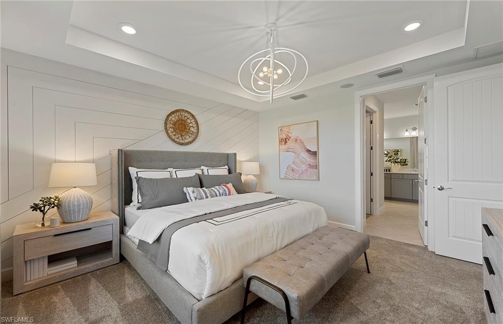 2142 Yellowfin Circle Naples, FL 34114 - Photo 18 of 31 a bedroom with a bed and a large mirror