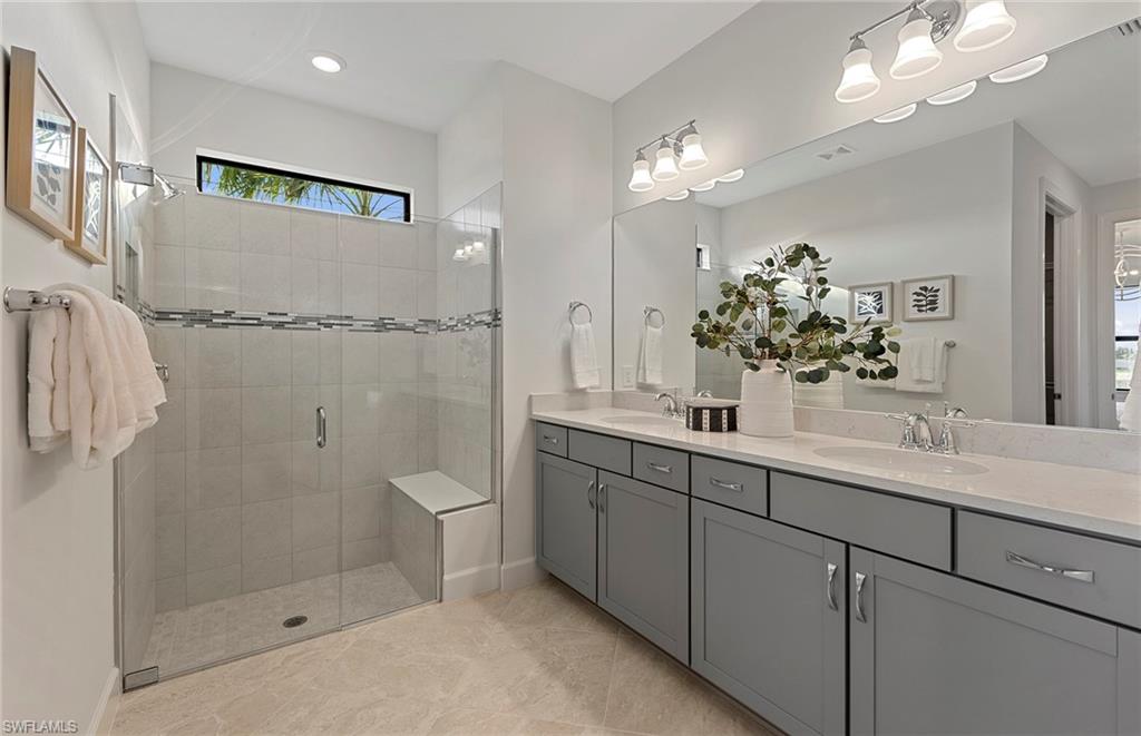 2142 Yellowfin Circle Naples, FL 34114 - Photo 20 of 31 a bathroom with a double vanity sink mirror and shower