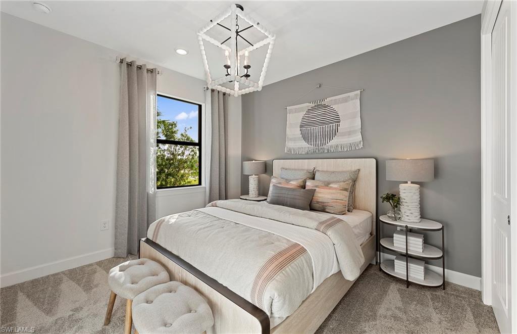 2142 Yellowfin Circle Naples, FL 34114 - Photo 21 of 31 a bedroom with a bed and a chandelier