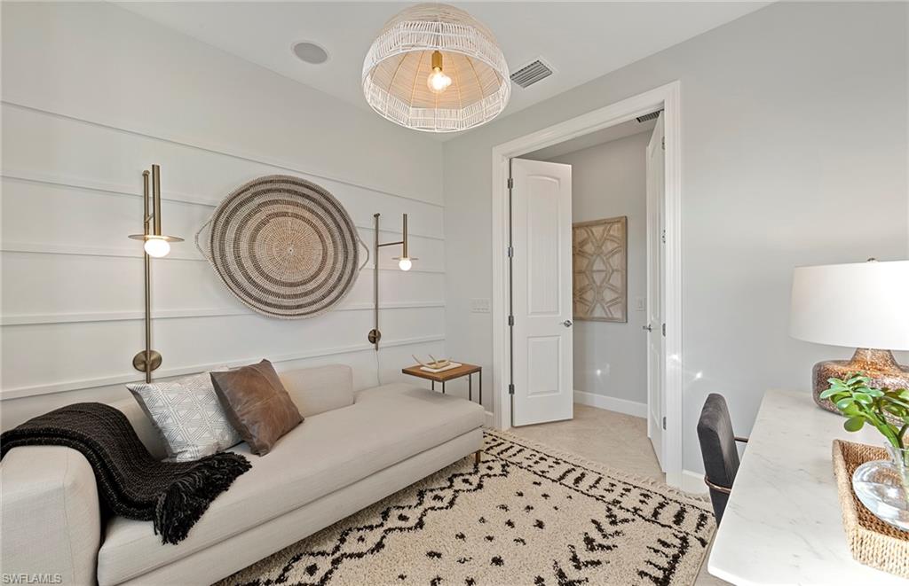2142 Yellowfin Circle Naples, FL 34114 - Photo 24 of 31 a living room with a couch and a stove with wooden floor