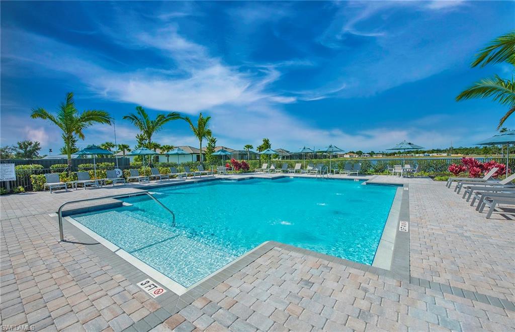 2142 Yellowfin Circle Naples, FL 34114 - Photo 26 of 31 a view of a lake with a building in the background