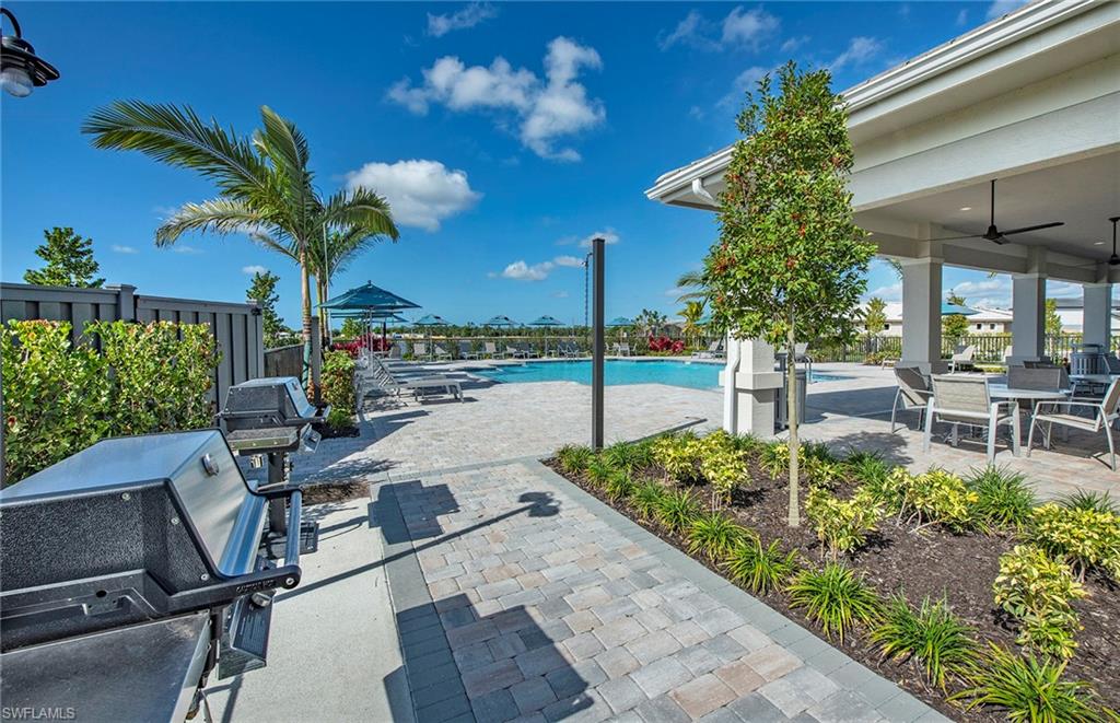 2142 Yellowfin Circle Naples, FL 34114 - Photo 29 of 31 a view of a porch with chairs and potted plants