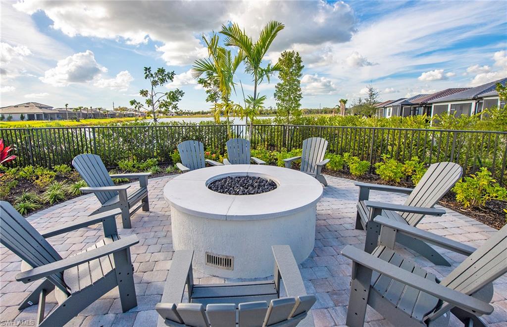 2142 Yellowfin Circle Naples, FL 34114 - Photo 31 of 31 a view of a chairs and table in patio with a lake view