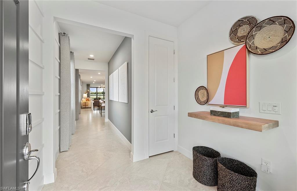 2142 Yellowfin Circle Naples, FL 34114 - Photo 7 of 31 a view of a livingroom with furniture and mirror