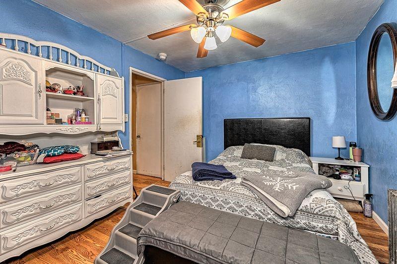 615 West 4th Avenue Derry, PA 15627 - Photo 13 of 28 a bedroom with a bed and a chandelier