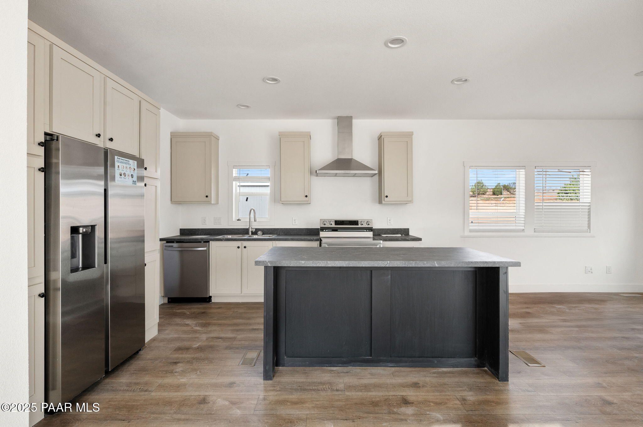 29 East Abra Road Paulden, AZ 86334 - Photo 7 of 22 a kitchen with stainless steel appliances granite countertop a sink stove and refrigerator