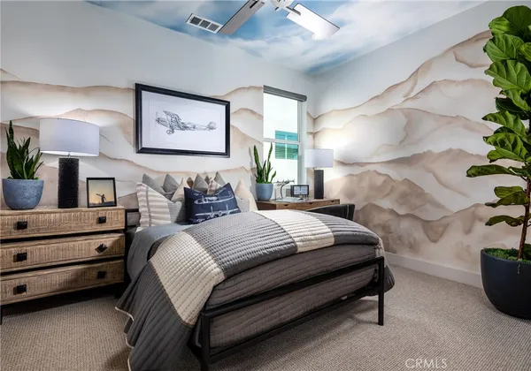 a bedroom with a bed and a potted plant