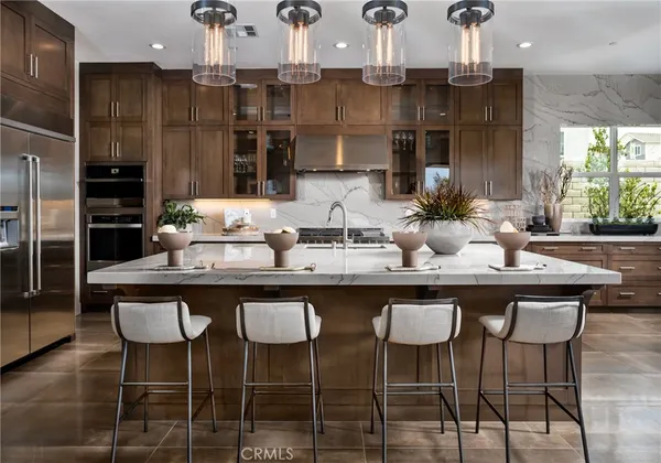 a view of a dining room with furniture wooden floor and a chandelier