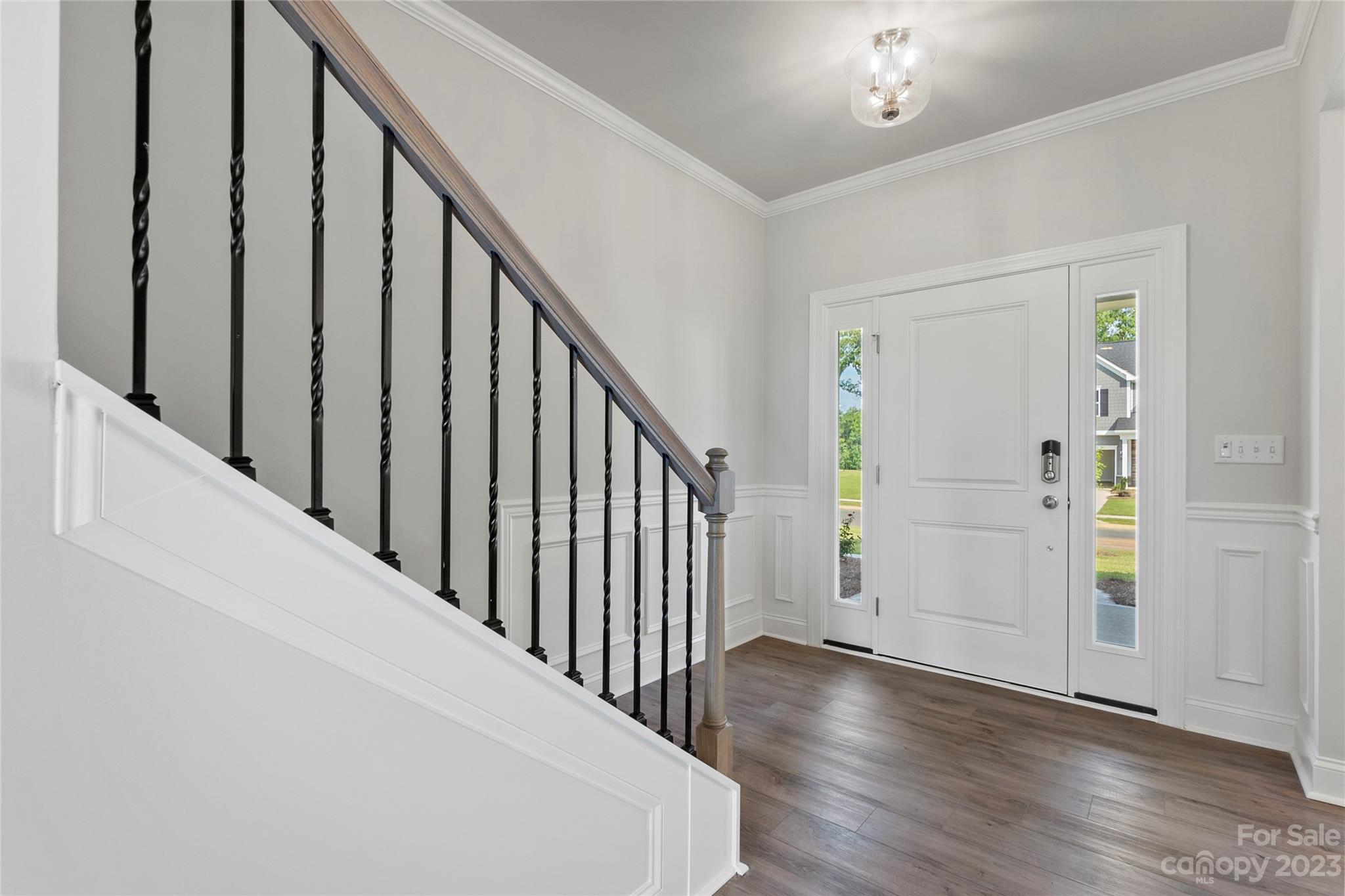 745 Sawgrass Rdg Court Rock Hill, SC 29732 - Photo 6 of 19 a view of a hallway with wooden floor and staircase