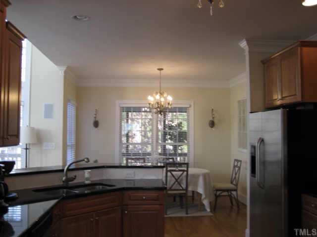 1132 Coram Fields Road Wake Forest, NC 27587 - Photo 7 of 10 Looking into kitchen from dining rm is a nice spacious breakfast rm~Beautiful upgraded lighting fixtures throughout~Hanging light matches wall sconces but they are not electrified