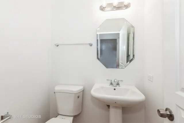 a bathroom with a sink toilet and mirror