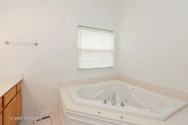 a white bath tub sitting next to a window