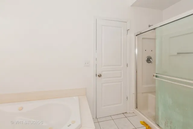 a bathroom with a shower and a glass door