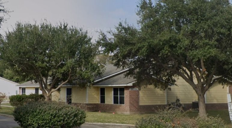 1803 Gray Street Palacios, TX 77465 - Photo 3 of 7 a front view of a house with garden