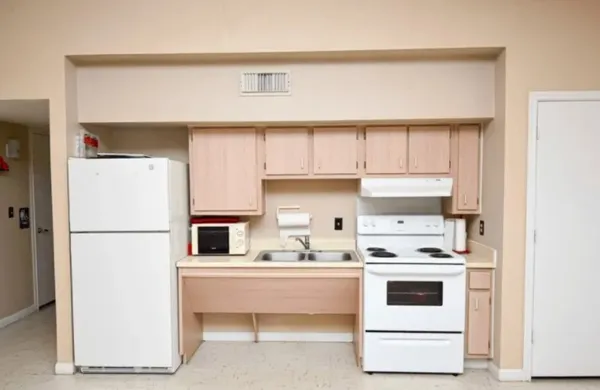 a kitchen with a white cabinets and white appliances