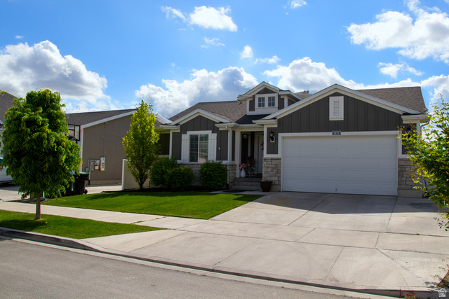 1415 North 3300th Street West Provo, UT 84601 - Photo 1 of 1 Craftsman house featuring board and batten siding, concrete driveway, stone siding, and an attached garage