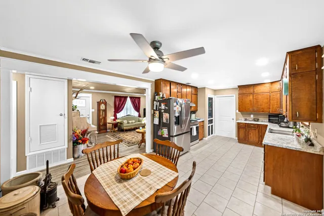 a view of a dining room with furniture a chandelier and wooden floor