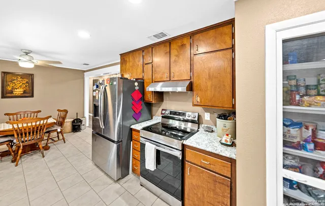 a kitchen with stainless steel appliances granite countertop a stove and a refrigerator
