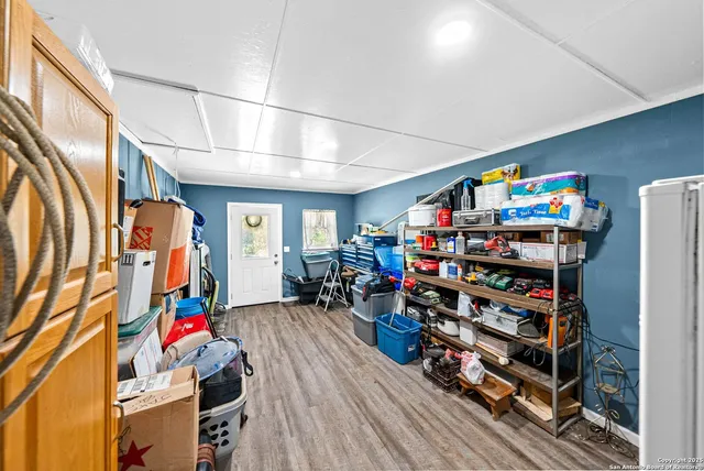 a room with lots of flowers and wooden cabinets