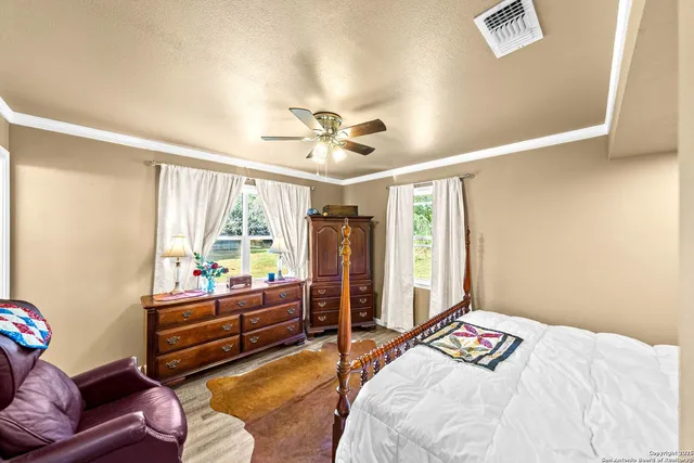 a bedroom with furniture and a large window