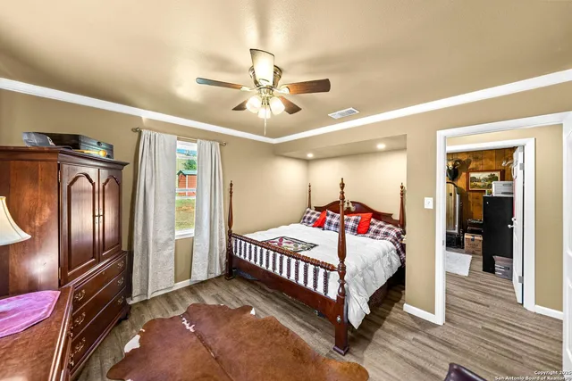 a bedroom with bed and wooden floor