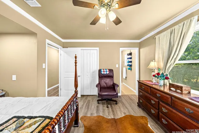 a bathroom with a granite countertop sink mirror vanity and toilet
