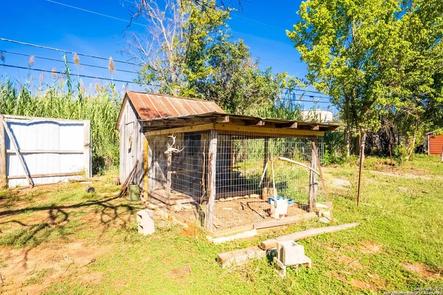 a backyard of a house with lots of green space and fountain