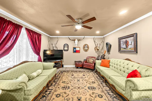 a living room with furniture kitchen and a window