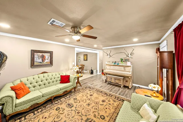 a living room with furniture ceiling fan and a rug