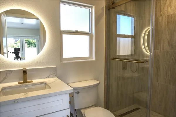 a bathroom with a sink toilet and shower