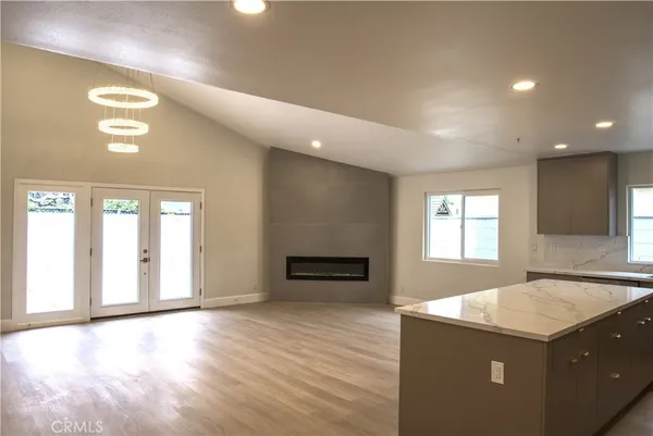 an empty room with windows and ceiling fan