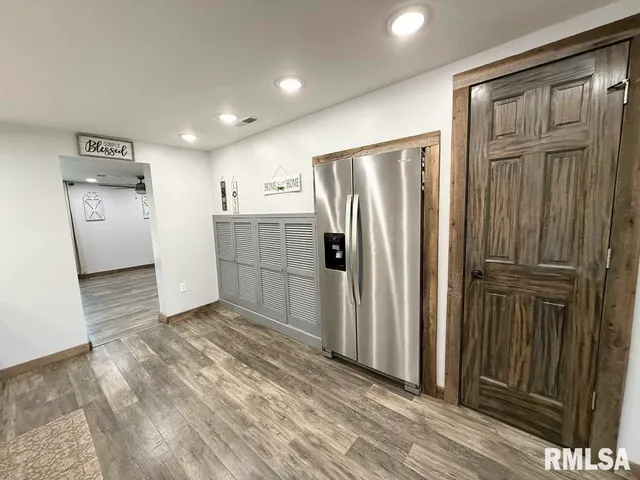 a view of a refrigerator in kitchen and wooden floor
