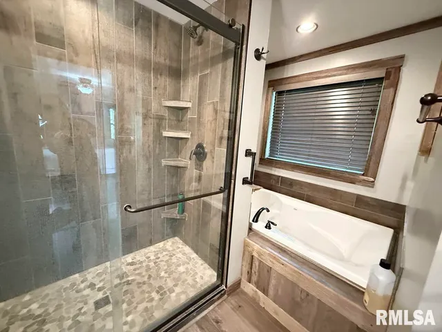 a bathroom with a tub and a shower