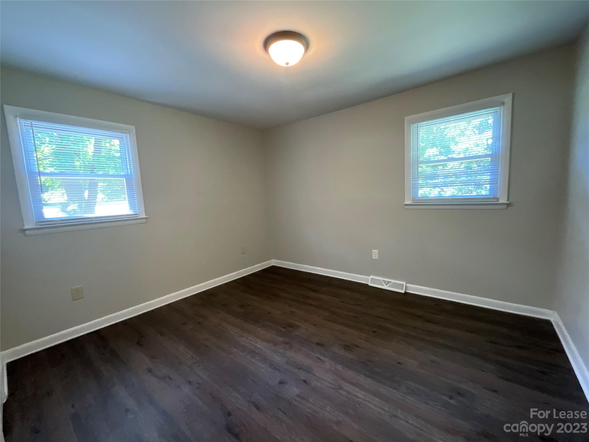 2006 Airport Road, Unit B Salisbury, NC 28147 - Photo 11 of 12 a view of an empty room with wooden floor and a window