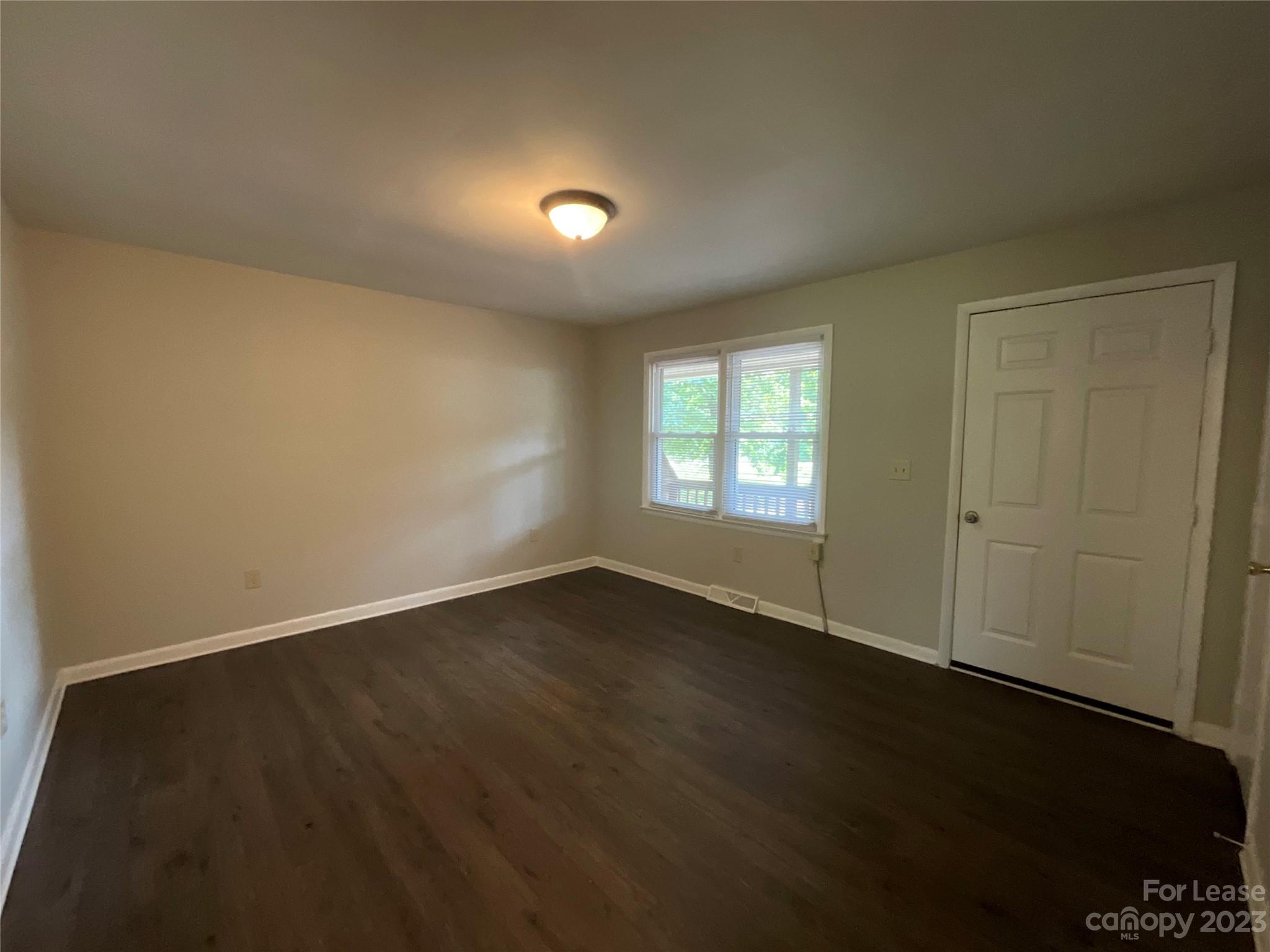 2006 Airport Road, Unit B Salisbury, NC 28147 - Photo 4 of 12 an empty room with wooden floor and windows