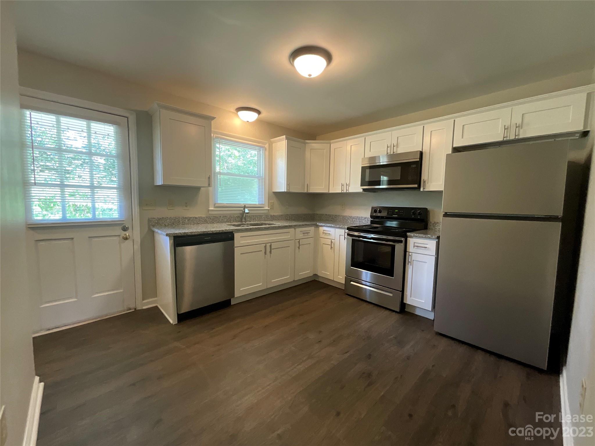 2006 Airport Road, Unit B Salisbury, NC 28147 - Photo 6 of 12 a kitchen with stainless steel appliances a refrigerator a sink a stove a microwave a sink a refrigerator and cabinets