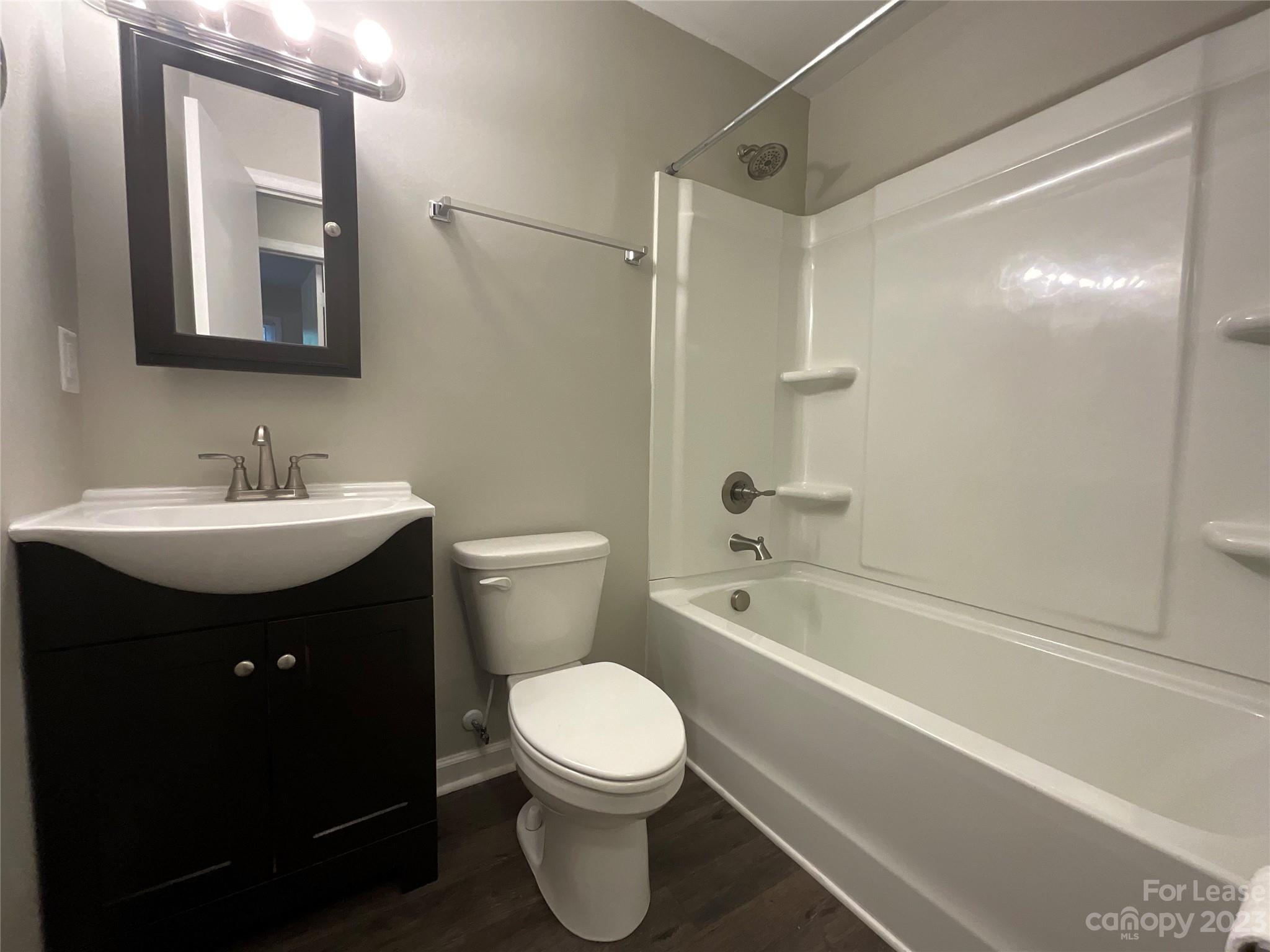 2006 Airport Road, Unit B Salisbury, NC 28147 - Photo 8 of 12 a bathroom with a sink toilet vanity and shower