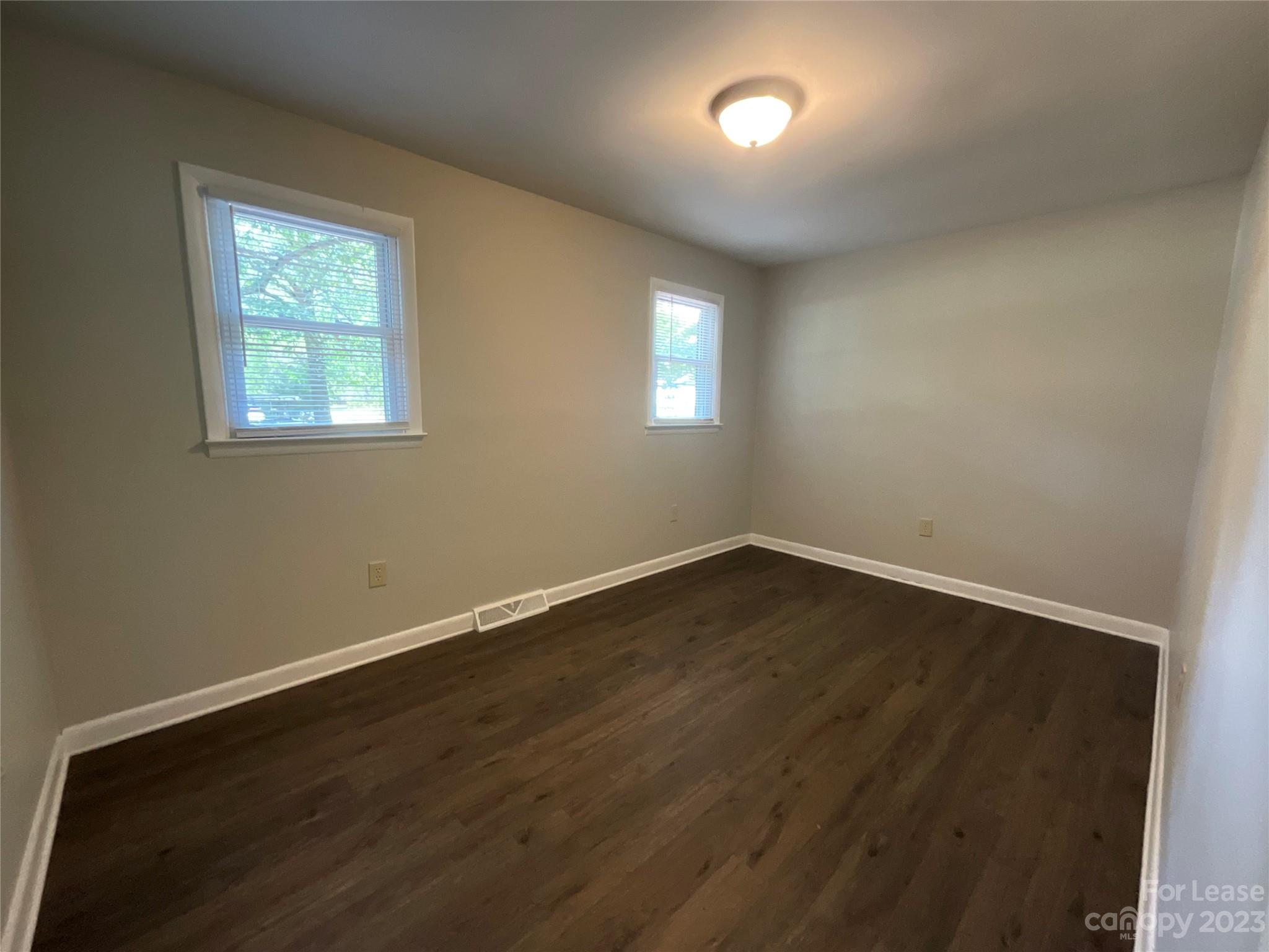 2006 Airport Road, Unit B Salisbury, NC 28147 - Photo 9 of 12 an empty room with wooden floor and windows