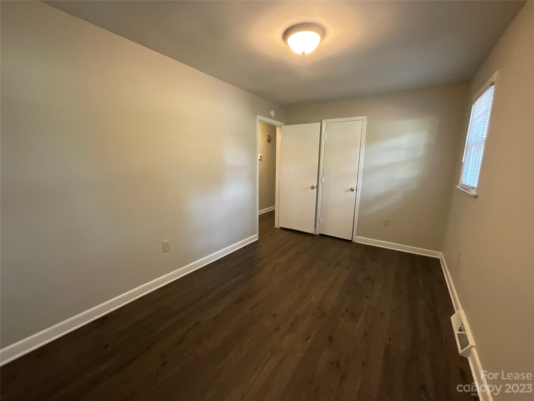 2006 Airport Road, Unit B Salisbury, NC 28147 - Photo 10 of 12 an empty room with wooden floor and windows