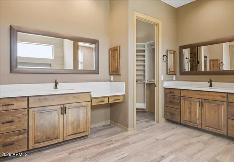 a spacious bathroom with a shower sink and mirror