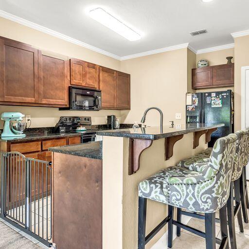 24 South Sand Palm Road, Unit 48 Freeport, FL 32439 - Photo 11 of 27 a kitchen with stainless steel appliances granite countertop a table chairs sink and cabinets