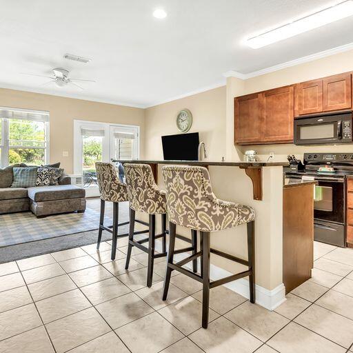 24 South Sand Palm Road, Unit 48 Freeport, FL 32439 - Photo 8 of 27 a living room with furniture a flat screen tv and a dining table