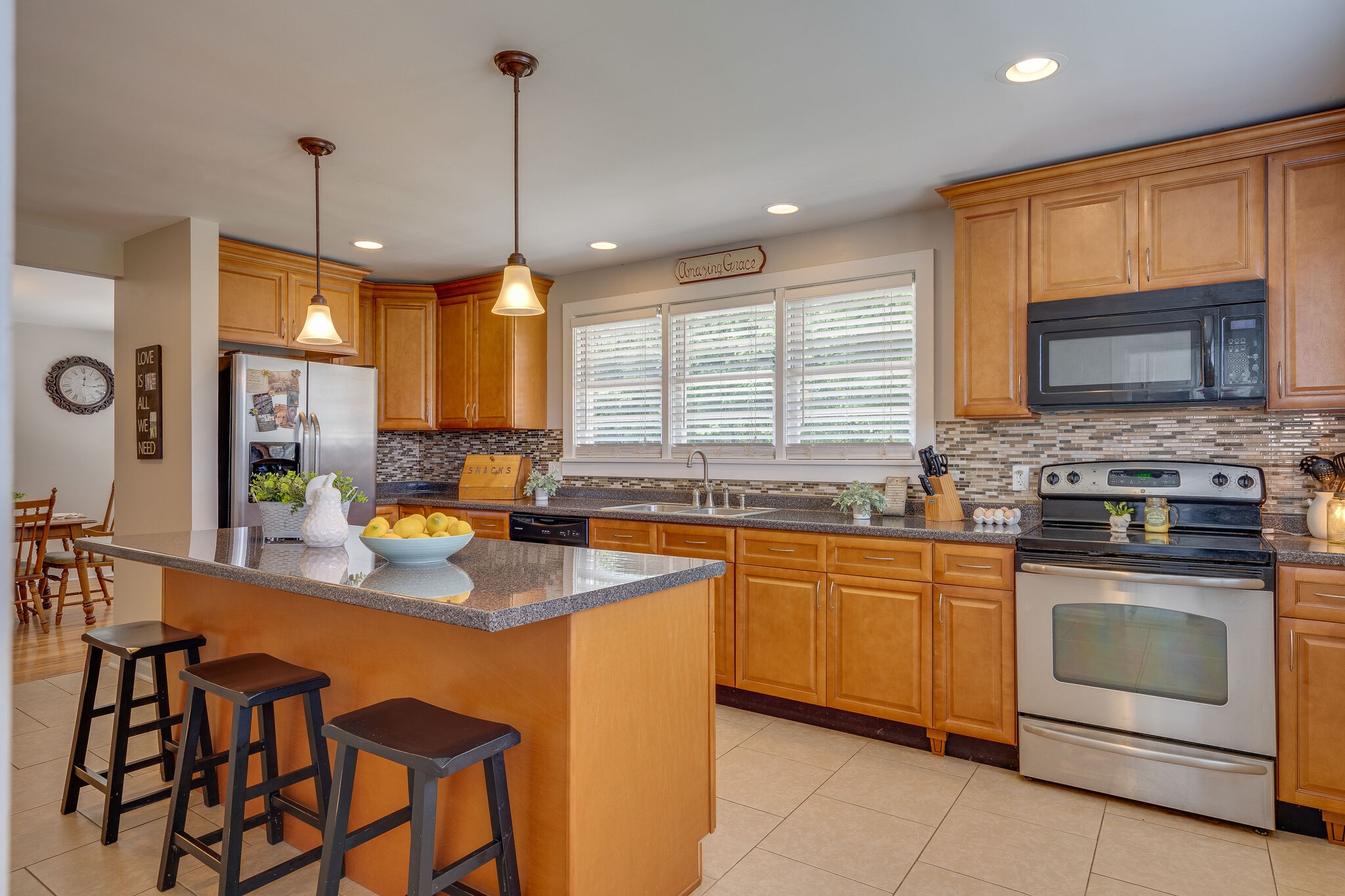 2241 Battle Creek Road Springfield, TN 37172 - Photo 18 of 32 a kitchen with stainless steel appliances granite countertop wooden cabinets a stove a sink a dining table and chairs