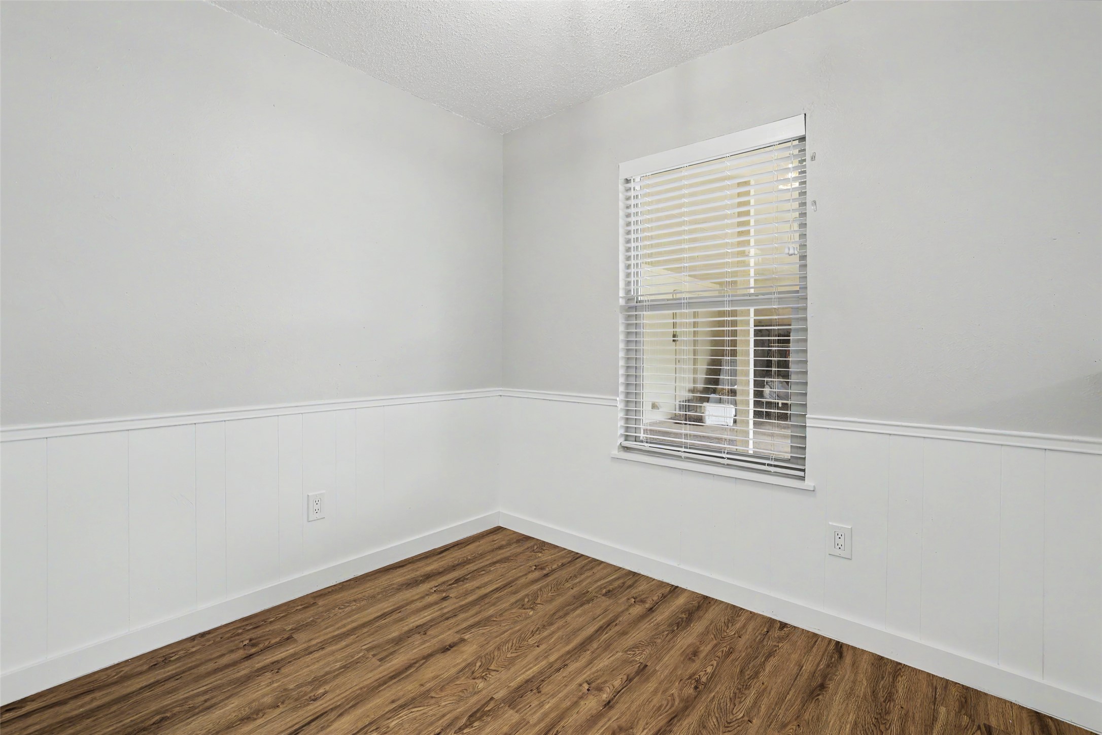 802 Ranch Road, Unit A Georgetown, TX 78628 - Photo 13 of 21 A well-lit room featuring durable wood flooring, ready for personalization.