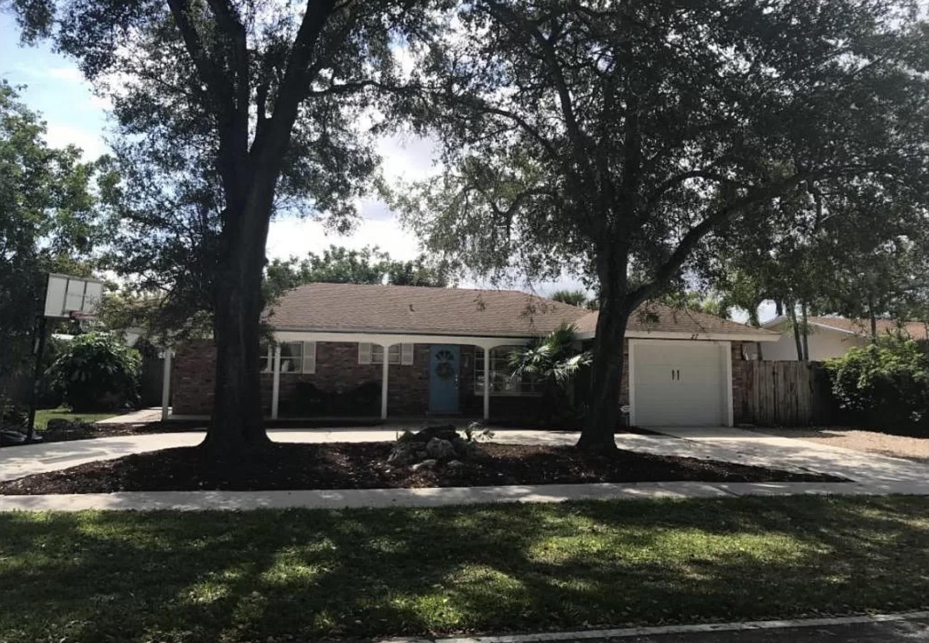 27 Pinehurst Lane Boca Raton, FL 33431 - Photo 1 of 12 a front view of a house with a yard