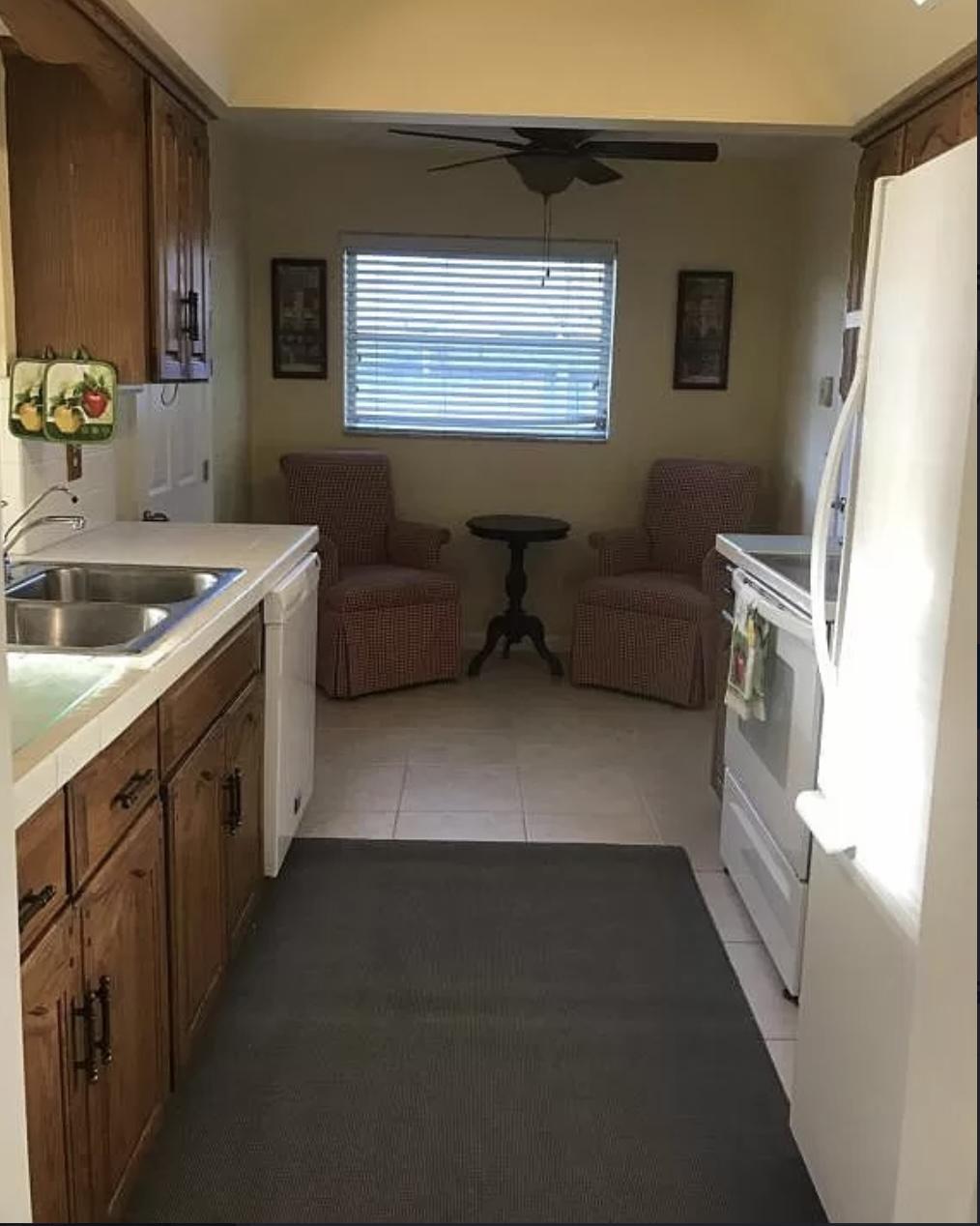 27 Pinehurst Lane Boca Raton, FL 33431 - Photo 5 of 12 a kitchen with a refrigerator and a sink