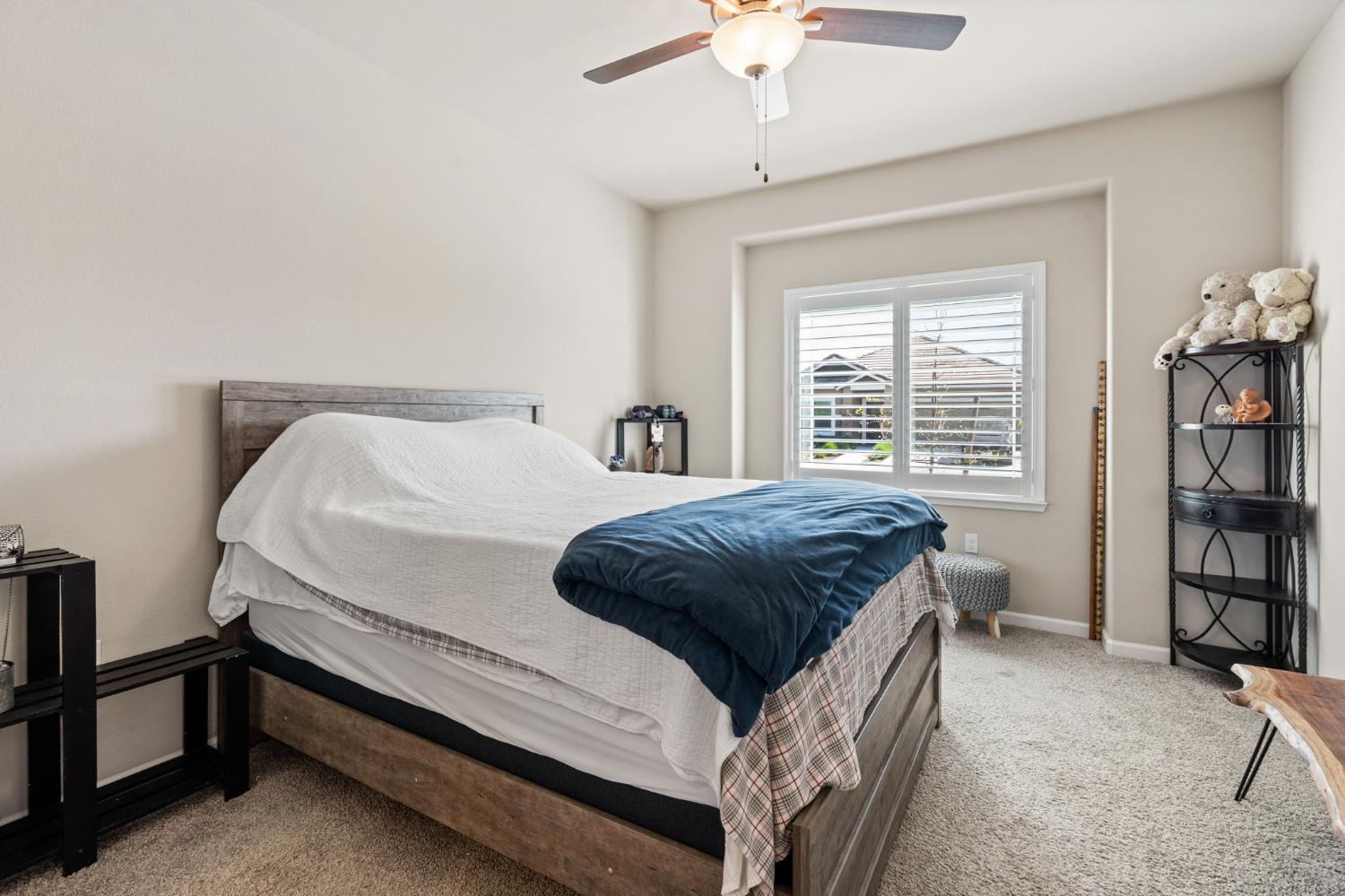 948 Hogan Road Galt, CA 95632 - Photo 14 of 20 a bedroom with a bed and a book shelf