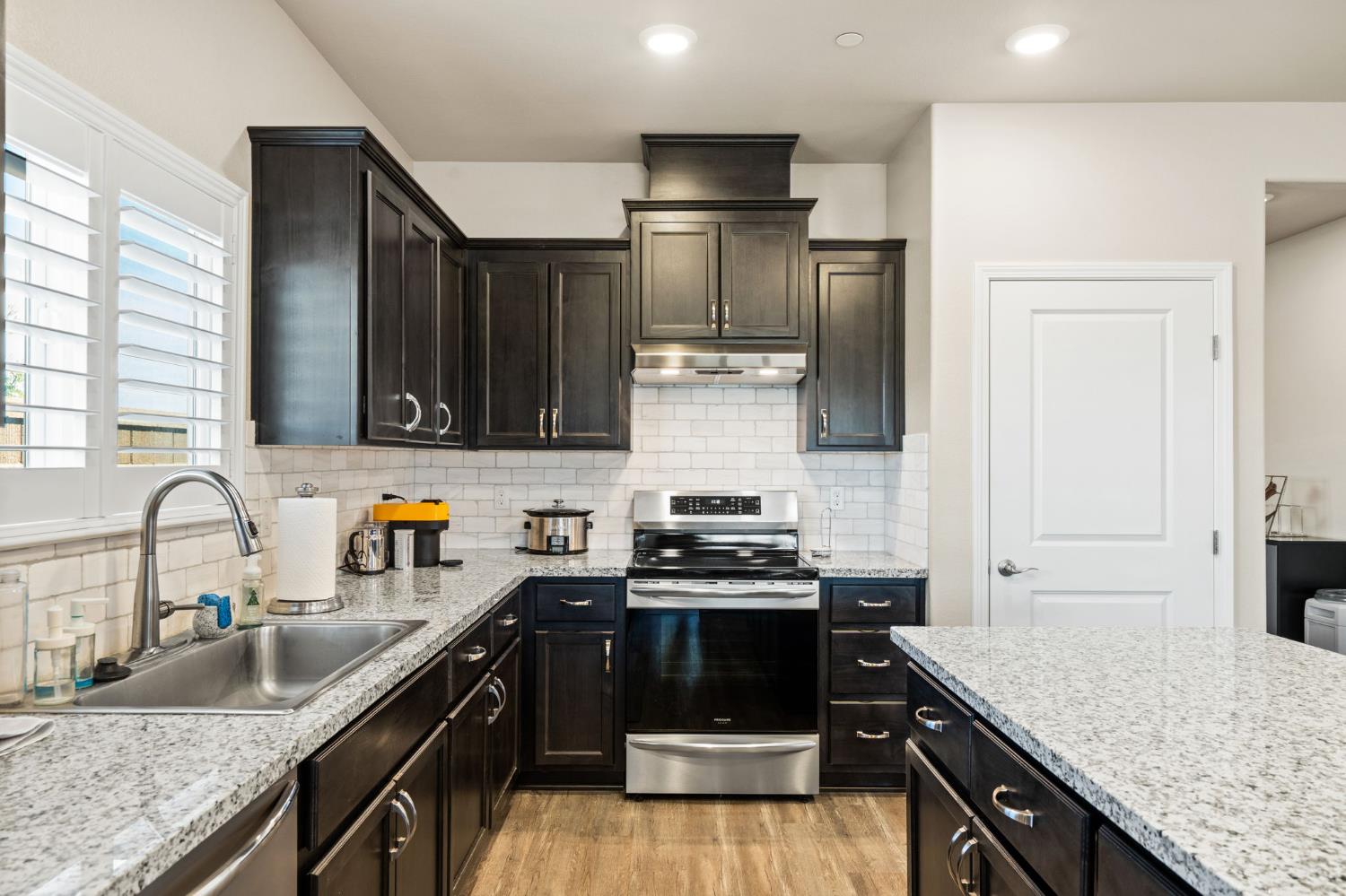 948 Hogan Road Galt, CA 95632 - Photo 8 of 20 a kitchen with stainless steel appliances granite countertop a sink stove and refrigerator