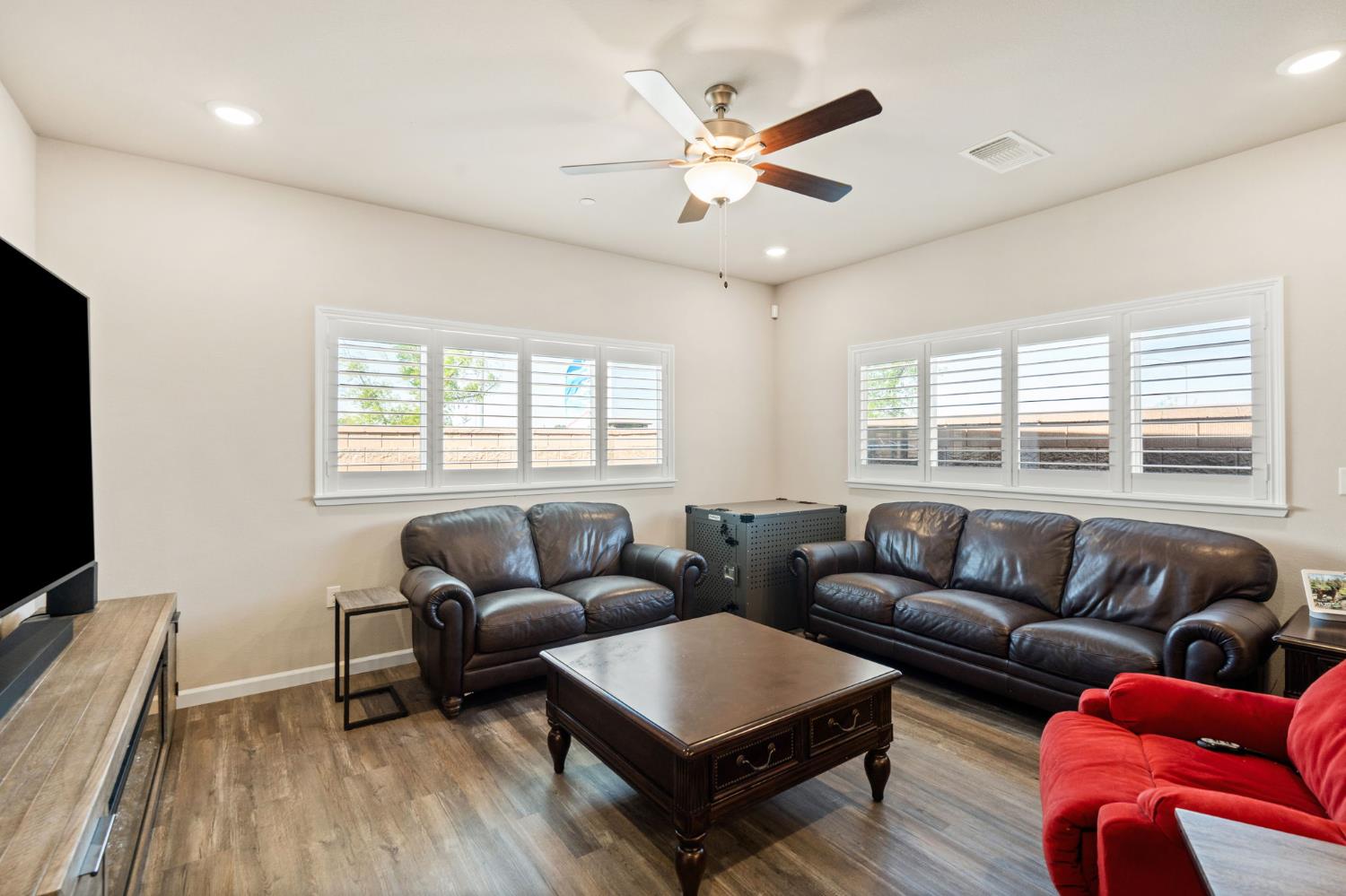 948 Hogan Road Galt, CA 95632 - Photo 9 of 20 a living room with furniture a flat screen tv and a large window